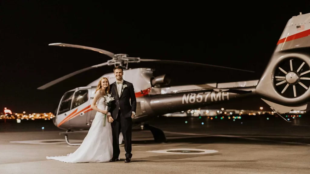 City Lights Helicopter Wedding - Couple standing in front of Helicopter