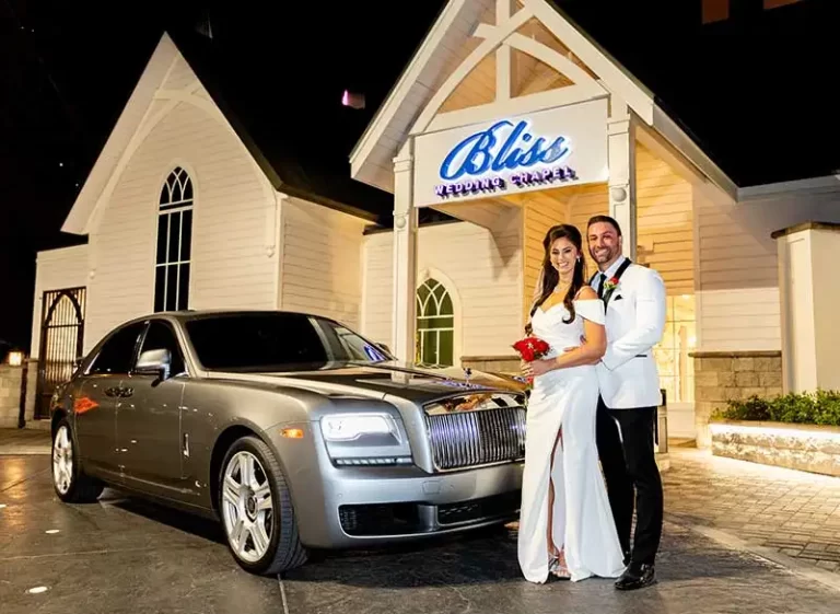Couple outside Bliss Wedding Chapel & Rolls Royce